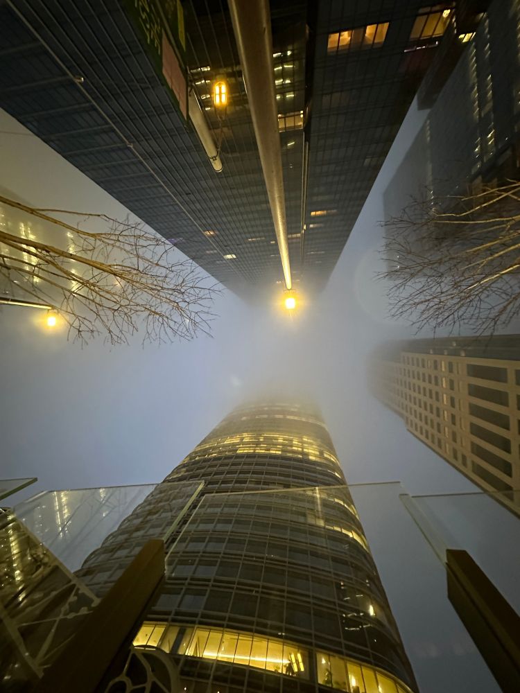 Looking up to the top of Salesforce Tower on a foggy day.
