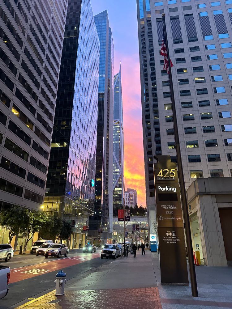 Fremont Street, San Francisco with brightly colored clouds showing between the buildings.
