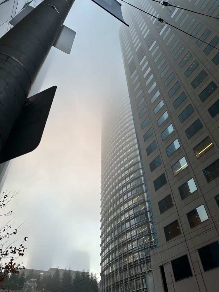 Salesforce Tower shrouded by fog at the top