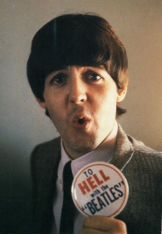 Paul McCartney holding a button that says: TO HELL with the “BEATLES”
