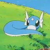 Dratini curled up and laying in the grass