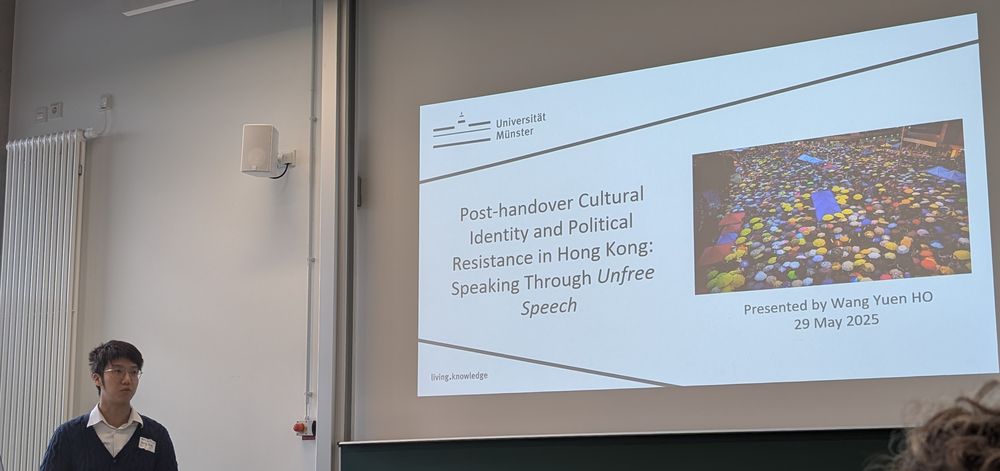 Wang Yuen Ho in front of his presentation slides