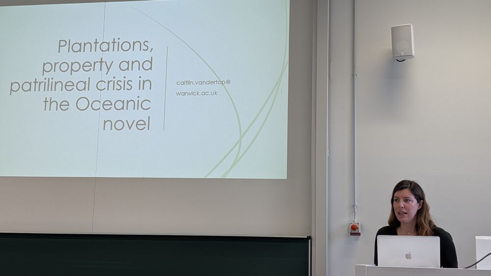 Caitlin Vandertop in front of her presentation 