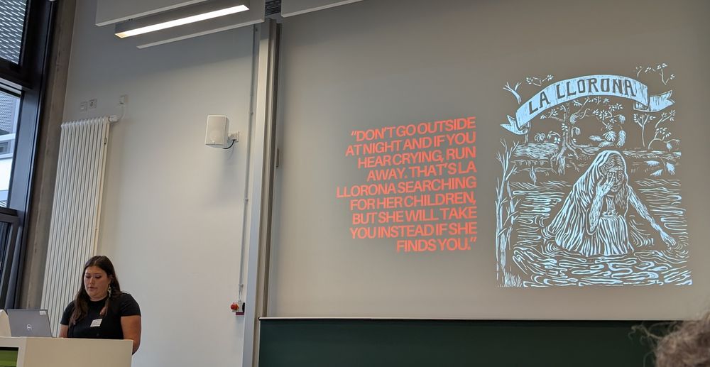 Corina Wieser-Cox in front of their presentation slides