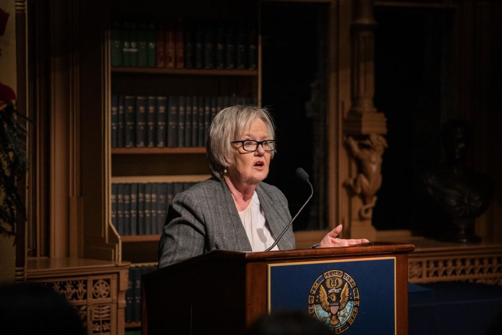 Professor Elizabeth Ferris speaks from the podium. 