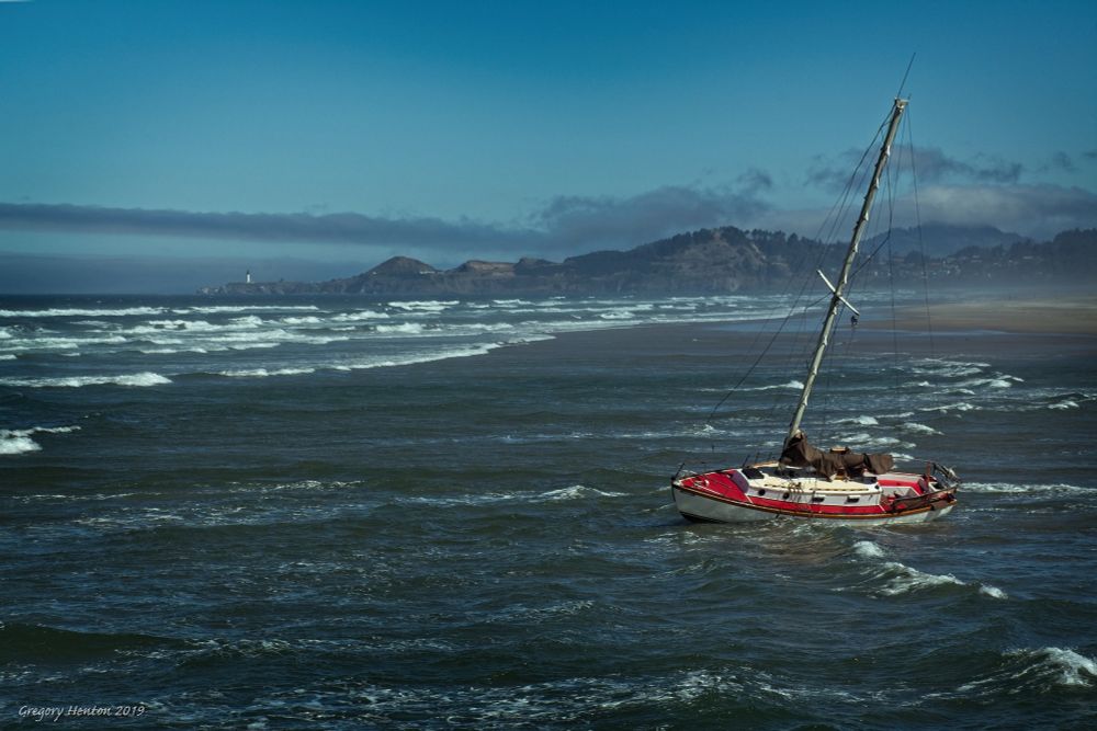 A shipwrecked sailboat on Nye Beach after missing the opening of the harbor jetties in the fog.  Sadly, when this happens, the boat are rarely salvaged, but rather destructively dismantled and hauled away.  Their keels quickly get buried in the sand and they can no longer be hauled back out to sea or across the beach.
