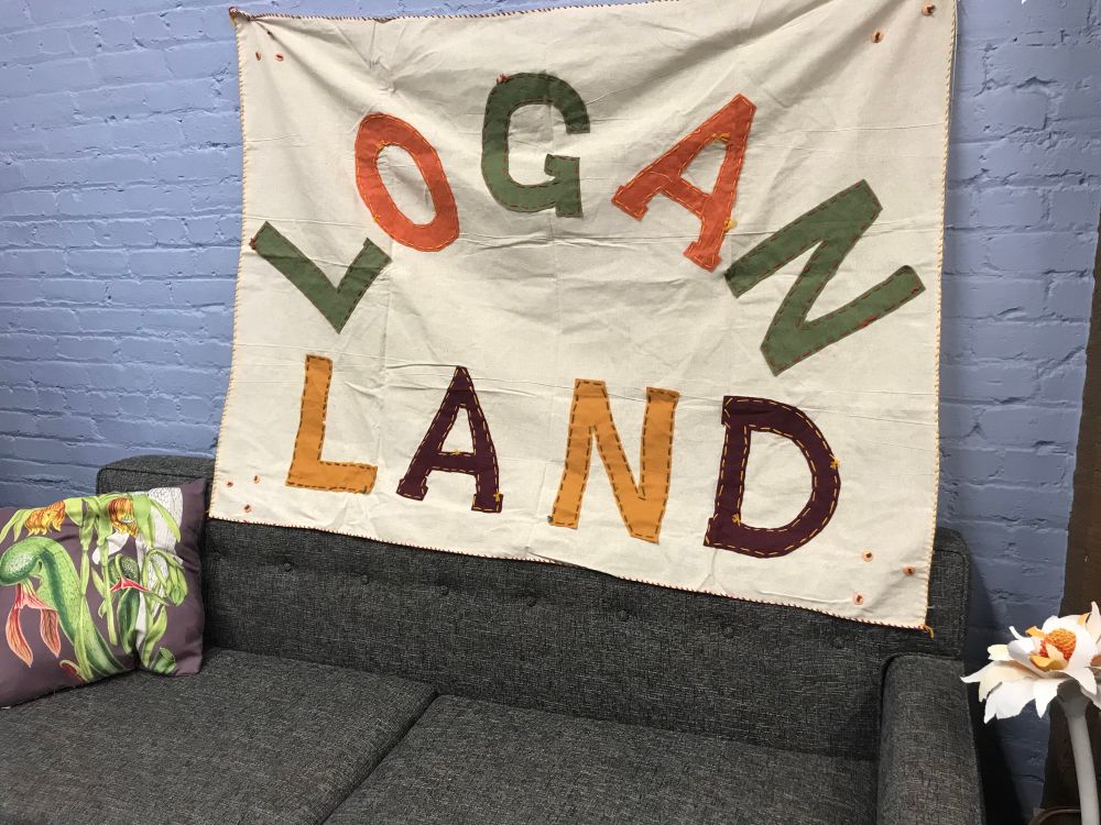 A cloth banner that reads LOGAN LAND. James Williams produced this to hang behind the band at the Logan Whitehurst Memorial concert at The Phoenix Theater in Petaluma. Idea comes from the song I Want To Live On The Moon. 
