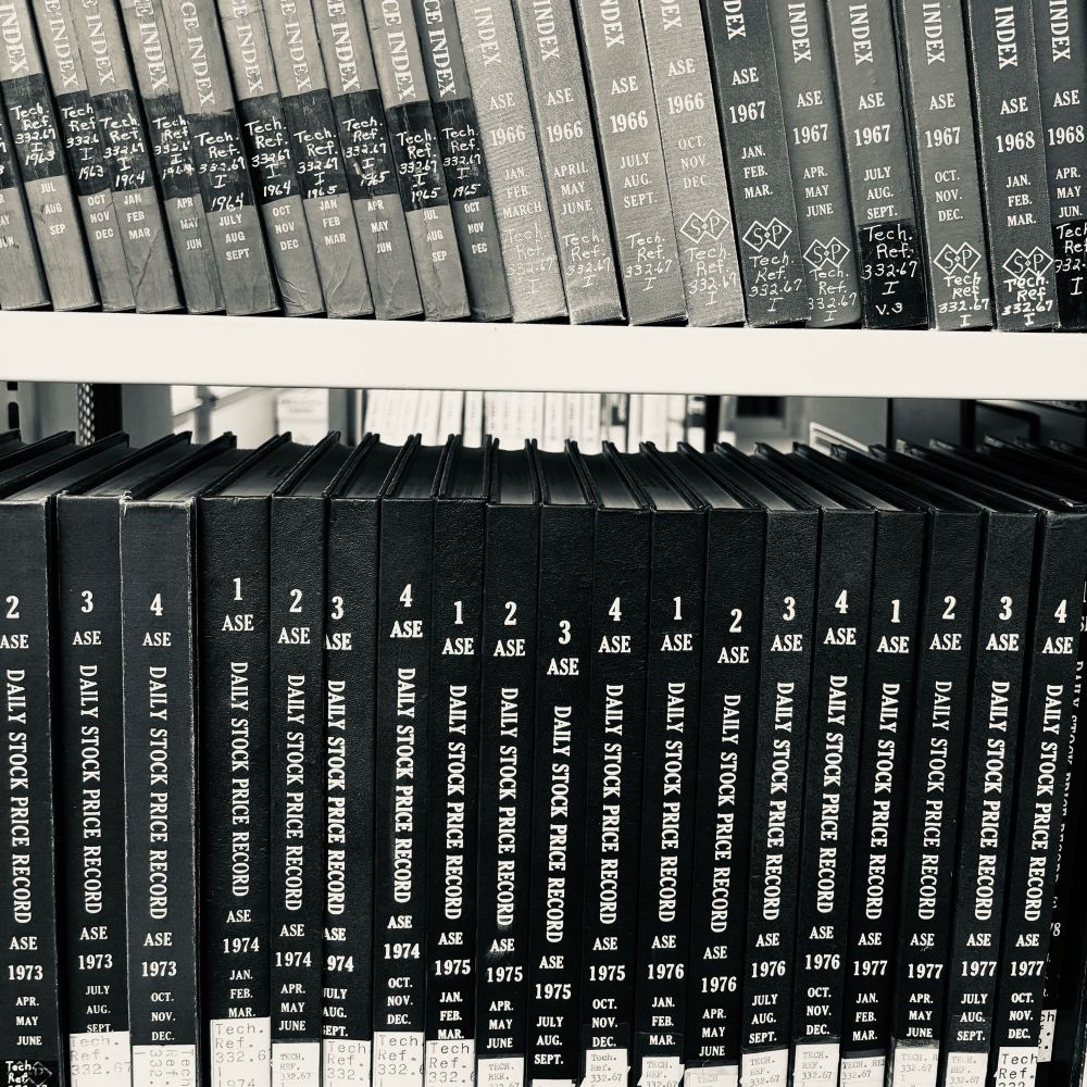 2 rows of books all titled “Daily stock price record” for every month in 1964-1977.