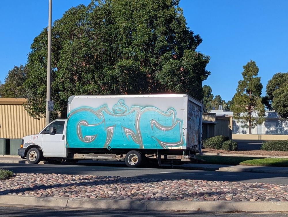 Truck with a graffiti marking that says "GTF"