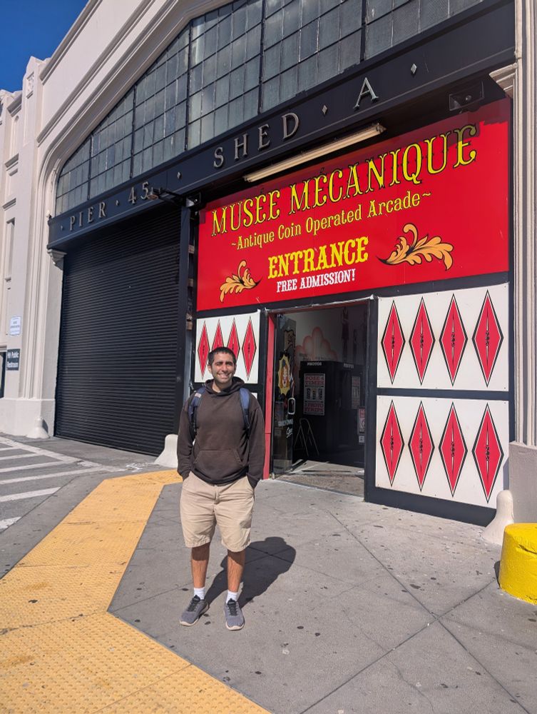 Niema standing in front of the entrance of Musée Mécanique