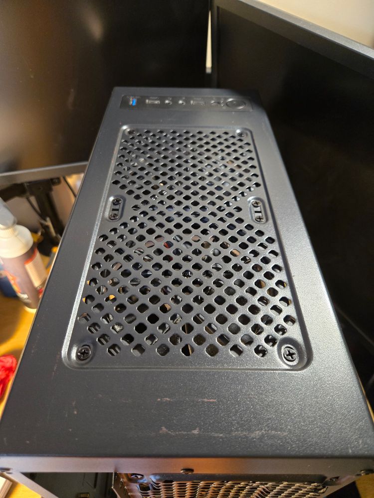 The top of a PC case, faint marks where tape was removed can be seen.

You can't smell it, but it reeks of isopropyl