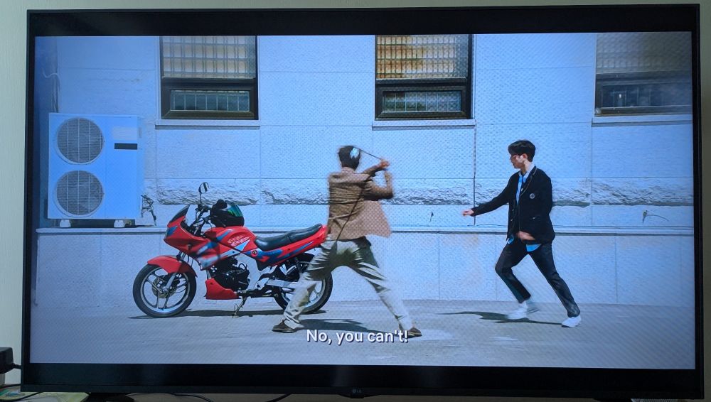 Still image from "The Devil Judge" of Professor Min trying to beat the shit out of Ga-on's motorbike with a golf club