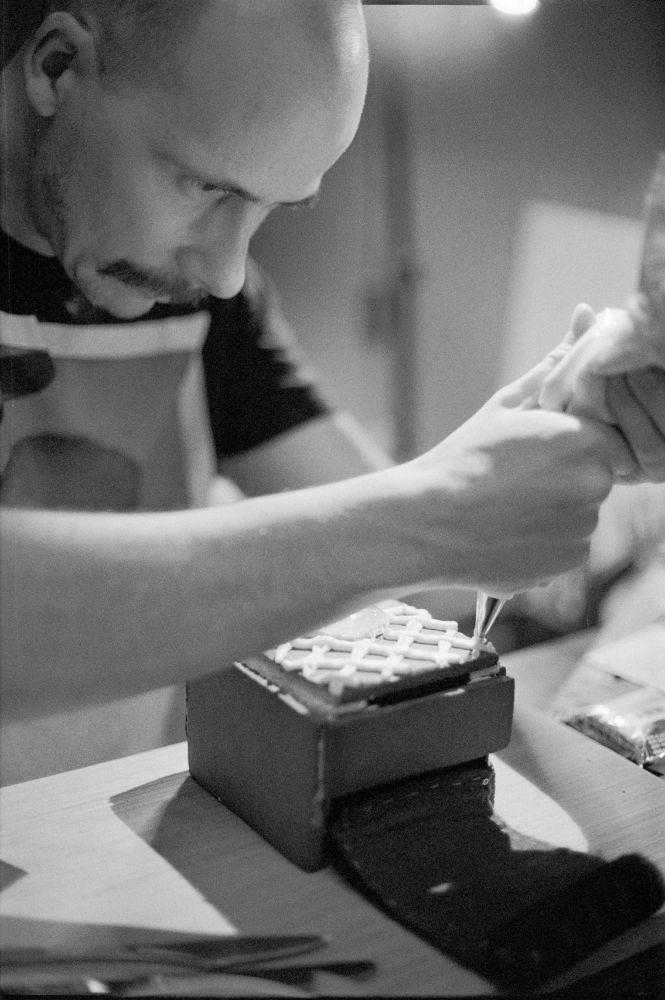 A photo of me finishing up the decorating the gingerbread film camera.