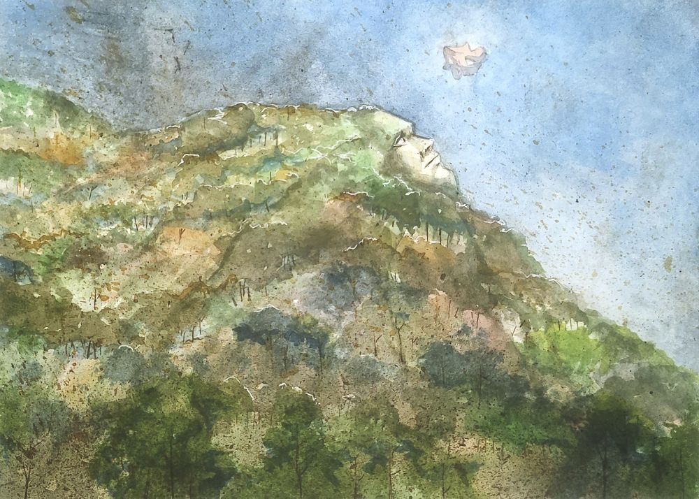 a forested mountainside with a human face on it's peak.  The face looks at a strange object floating above it.