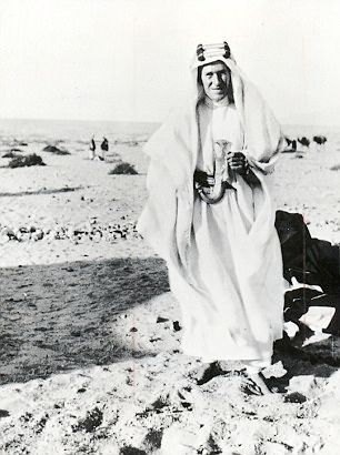 Photo of T.E. Lawrence wearing a white robe and a keffiyeh