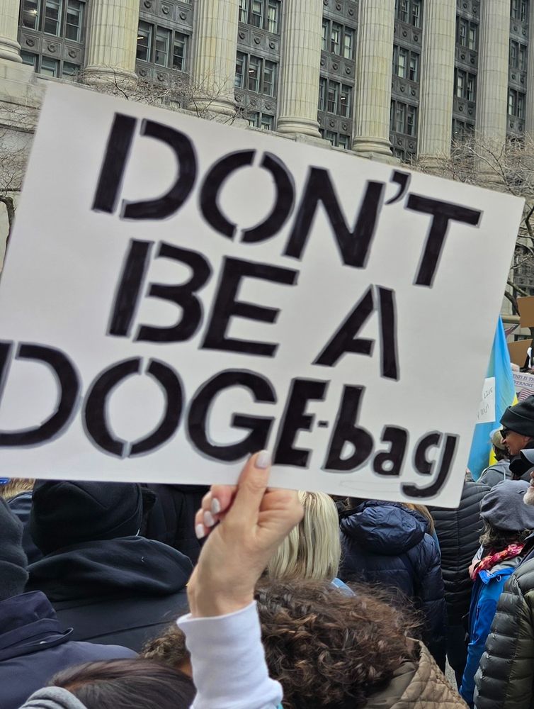 Sign that says Don't Be A DOGEbag.