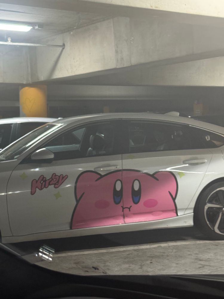 White car with a pink cartoon Kirby 