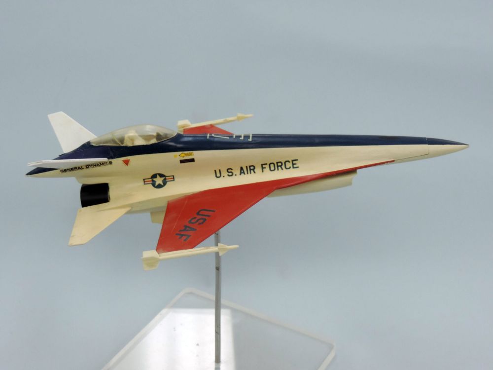 Desk model of an F16 in demonstration colors with a rear mounted cockpit