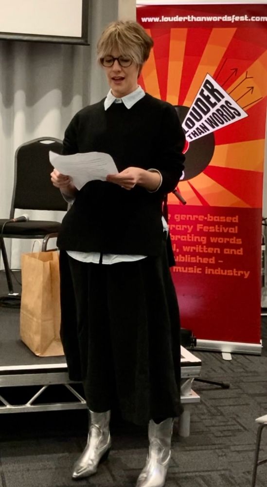 Erin Braithwaite reading out her winning entry for the Wilko Johnson Award at Louder Than Words music literature festival 