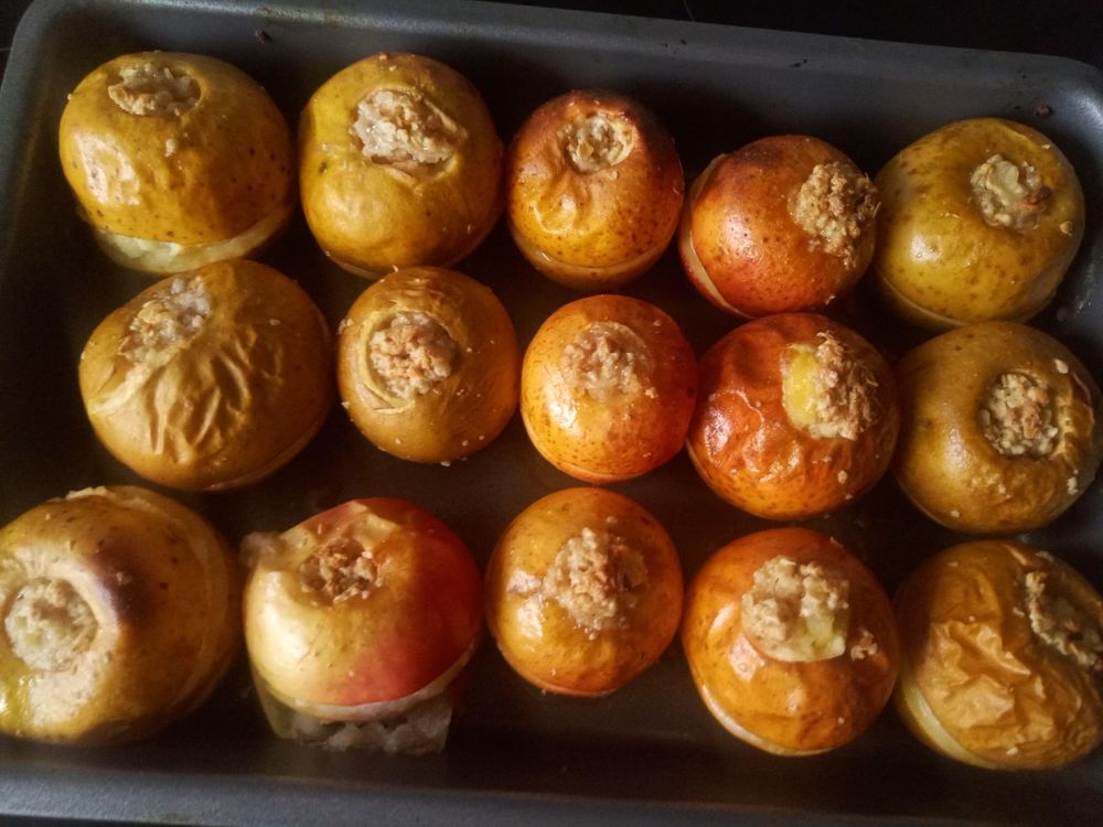 A tray of baked apples with a flapjack stuffing