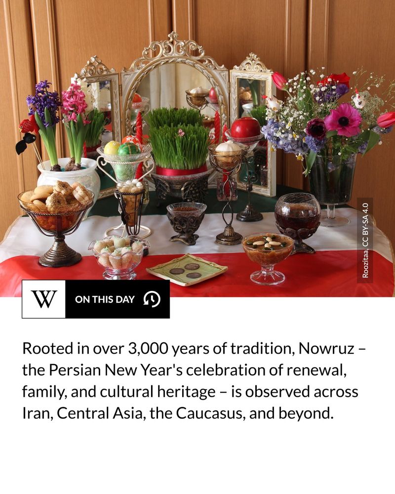 A Haft-Seen table set for Nowruz, featuring a mirror, candles, flowers, decorative eggs, sweets, fruits, coins, and a bowl of Sabzeh (sprouted wheatgrass), symbolizing renewal and prosperity. Text says: Rooted in over 3,000 years of tradition, Nowruz – the Persian New Year's celebration of renewal, family, and cultural heritage – is observed across Iran, Central Asia, the Caucasus, and beyond.