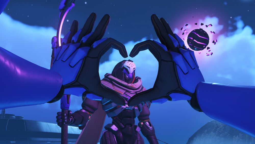 Ramattra is standing on the coast of Busan downtown, staring at the orb that is normally in his staff. This shot is taken from D.va's perspective, her hands forming a heart shape around Ramattra's face. This picture is my legacy they are SO adorable here.