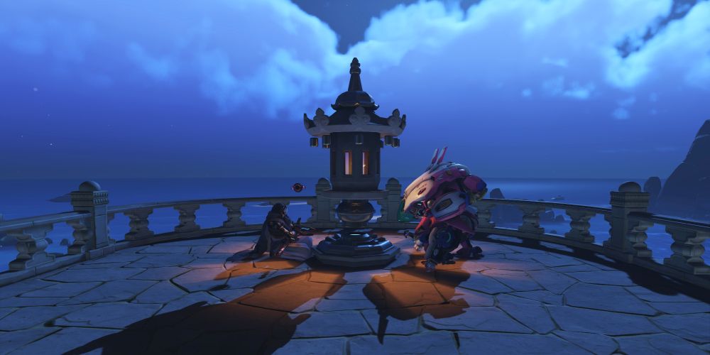 Wide shot showing Ramattra and D.va in the same poses, facing in each other's direction. I'm gonna be honest I don't know what the little pillar is between them but it looks like a cool and serene location!