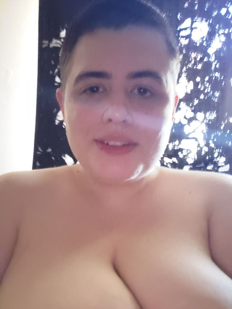 A photo of me nude with my hair buzzed short and my cleavage visible