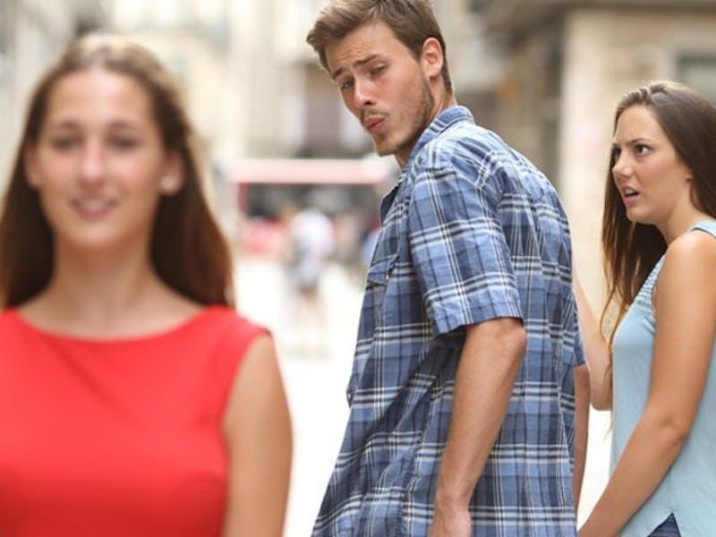 The distracted boyfriend meme where a guy is with his girlfriend but is leering at another woman walking away from them.