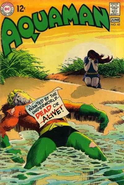 The cover of Aquaman #45, showing an unconscious or dead Aquaman on a beach on his back, half his body in the surf. A note on his body says 'Wanted by the Underworld...Dead or Alive!' with the word alive crossed out in red. A woman sits on her knees on a nearby sand dune, the setting sun at her back, face in her hands and overcome with emotion and seeing Aquaman this way.