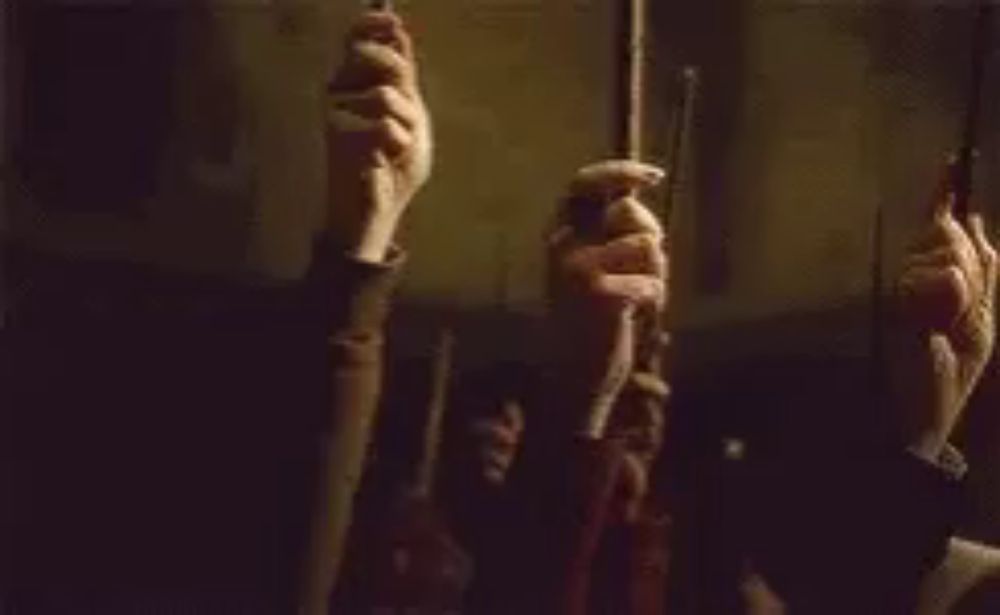 a group of people are holding candles in their hands .