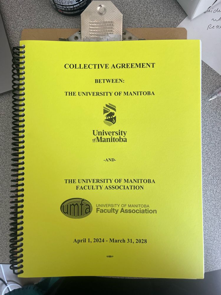 A bright yellow spiral bound copy of the collective agreement between the university of manitoba and the university of Manitoba faculty association for April 1, 2024 - March 31, 2028