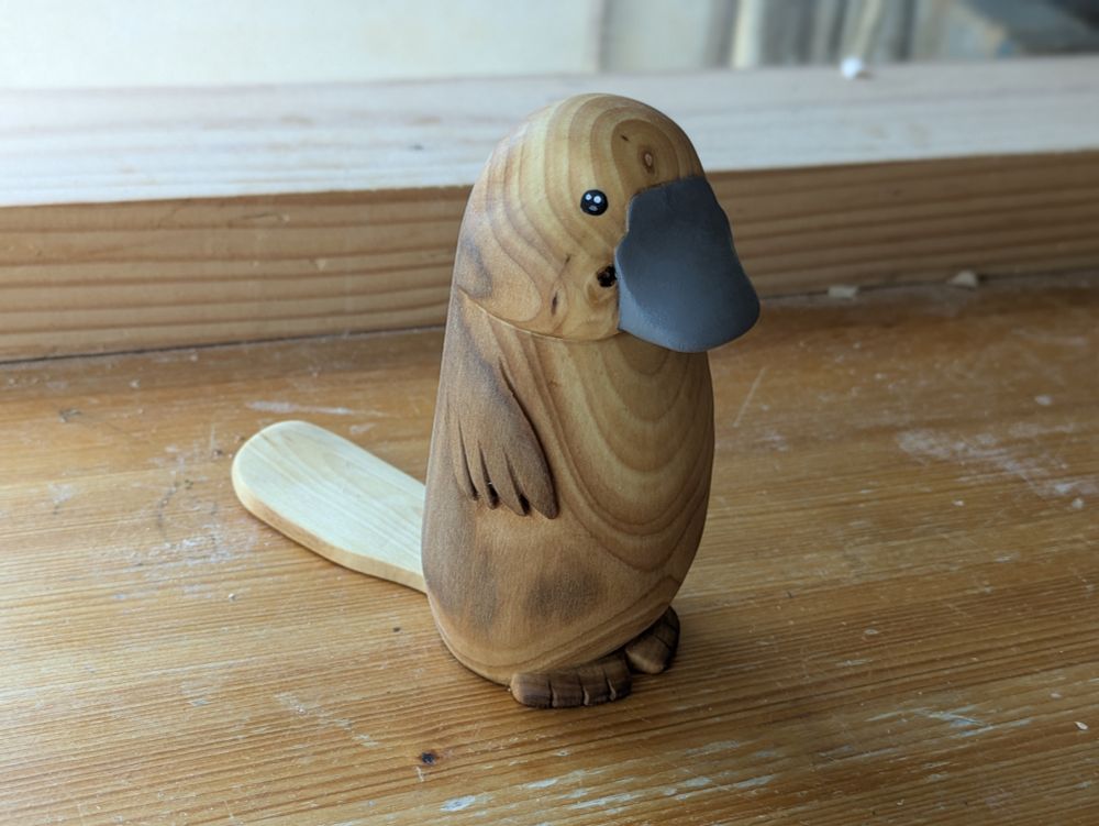 Woodcarved platypus on a workbench