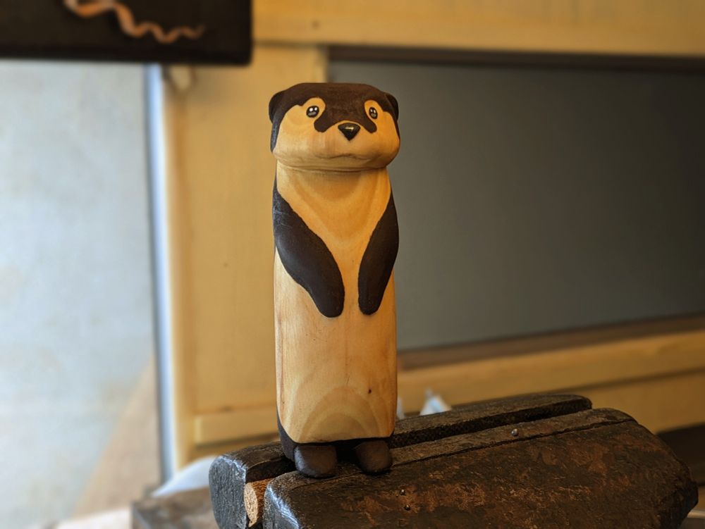 Wood sculpture of a standing otter