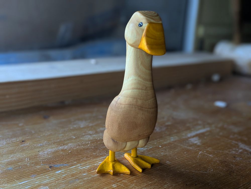 Woodcarved goose on a workbench 