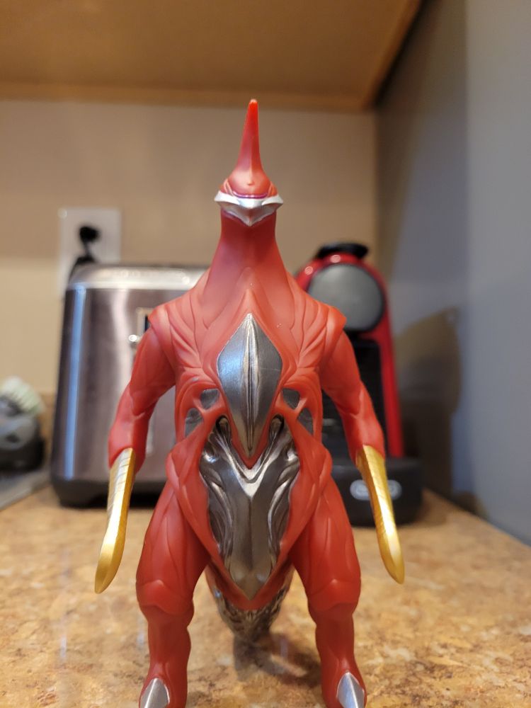 bright red monster toy on counter top