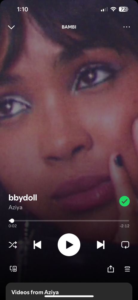 Screenshot of the Spotify visual for “bbydoll” by Aziya. A closeup of Aziya’s face as she looks wistfully off camera. 