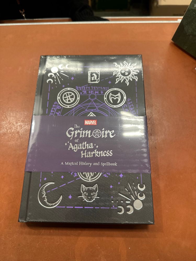 A picture of an unopened copy of “The Grimoire of Agatha Harkness: A Modern Magical History and Spellbook.”