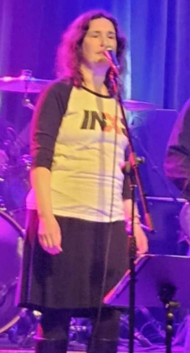 Singing Don’t Change. Shirt says “INXS.”