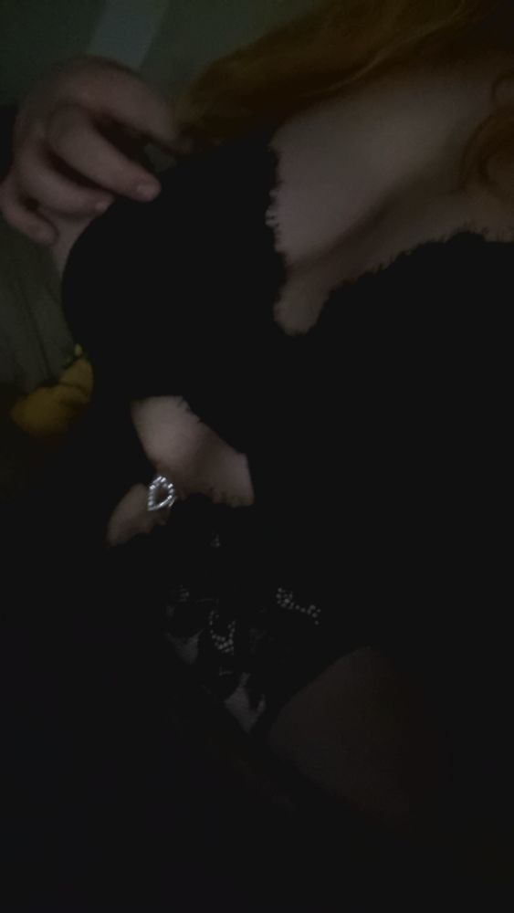 Jonesy in black lace lingerie that has a mini heart buckle 