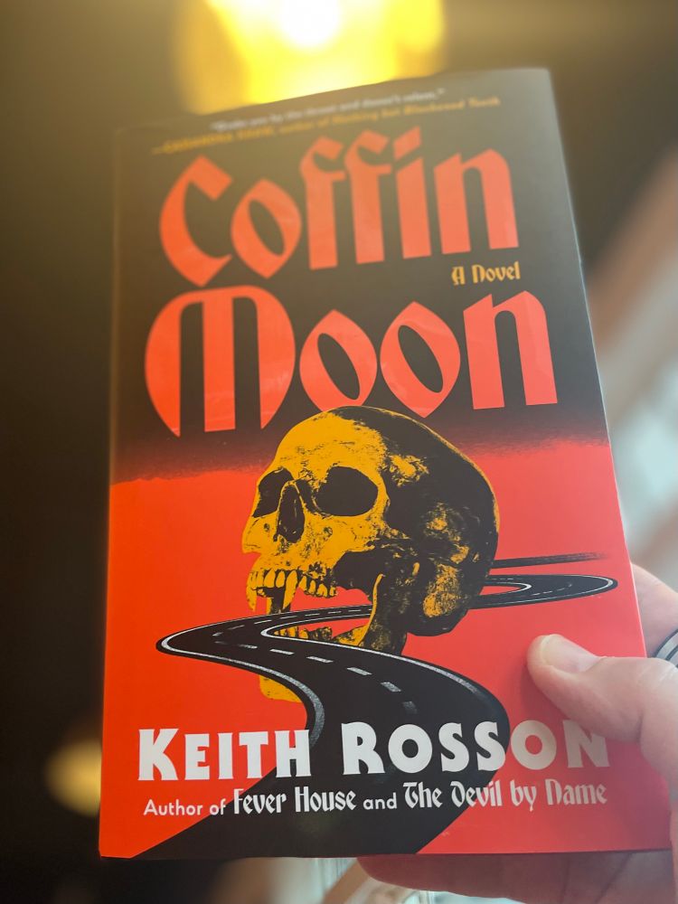 Me holding up my copy of COFFIN MOON (with that amazing cover of a skull and a road) by rock and roll horror king, Keith Rosson