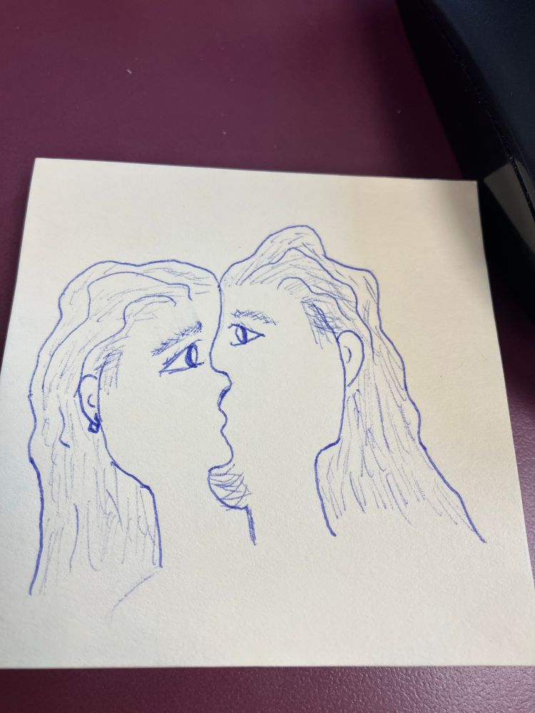 An interpretive piece depicting two faces kissing, which when viewed from the front can also look like a single face.