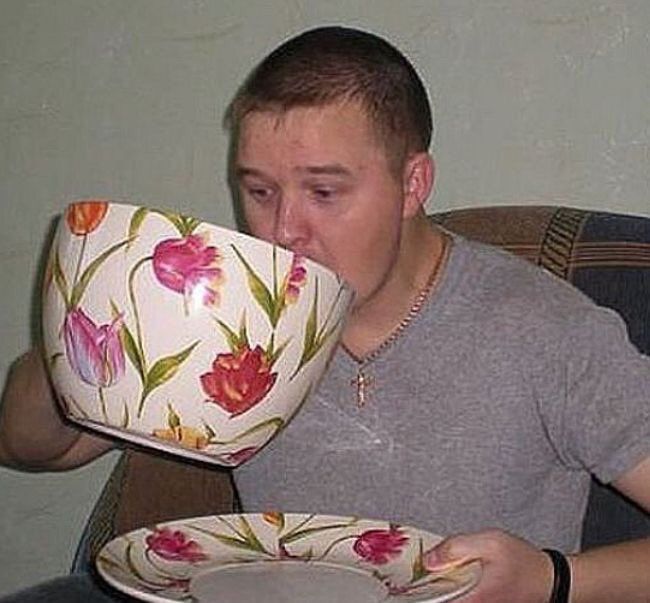 an anguished man drinks from a giant tea cup (with matching saucer)