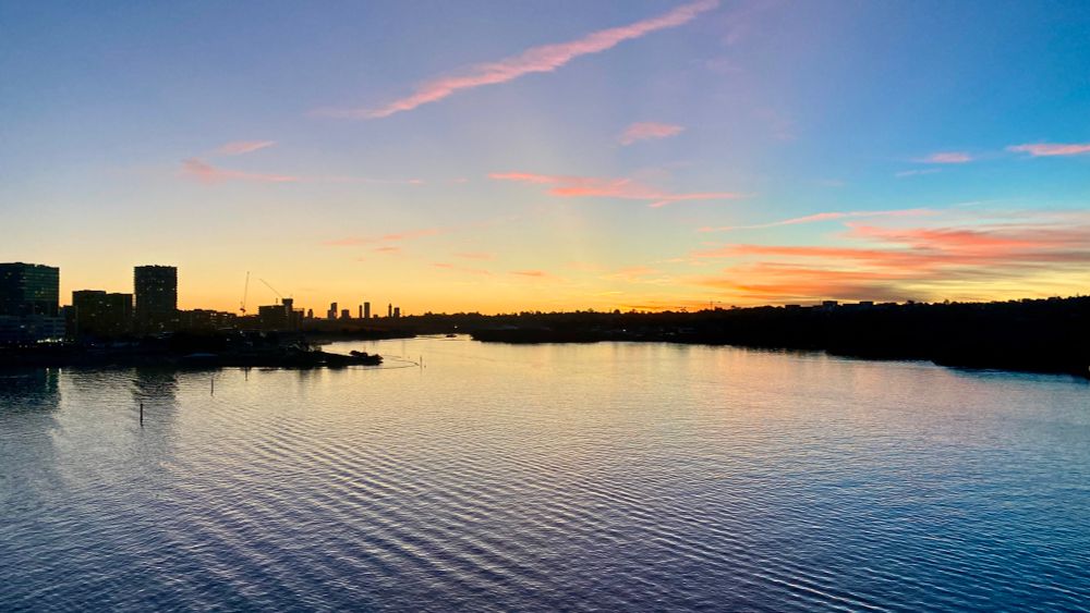 View across a serene Parramatta river towards a sunset over Parramatta