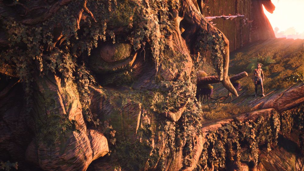 Close Up of Benjy's face as part of a huge tree and a small Hazel standing in his shoulder