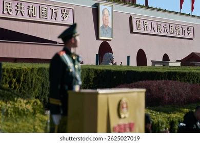 Mao portrait on a building, soldier is looking at it