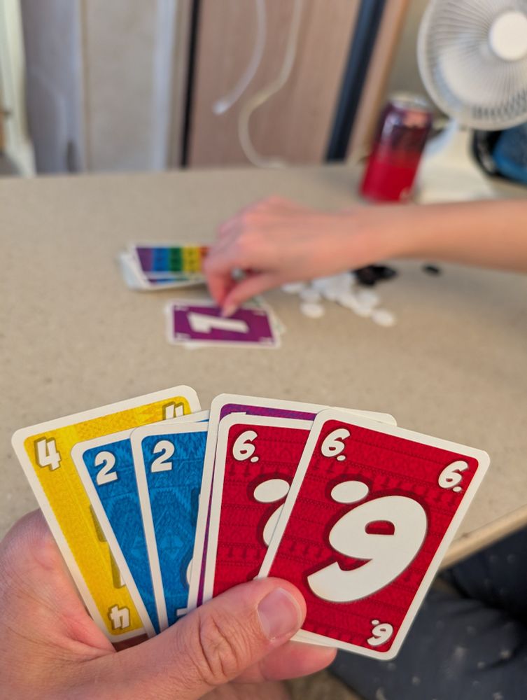 LLAMA cards in hand with draw pile in the background