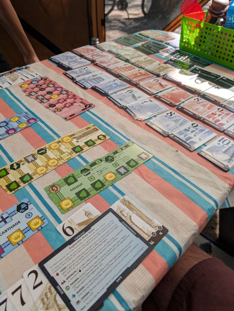 Innovation Ultimate with the Echoes of the Past and Cities of Destiny expansions on an picnic table