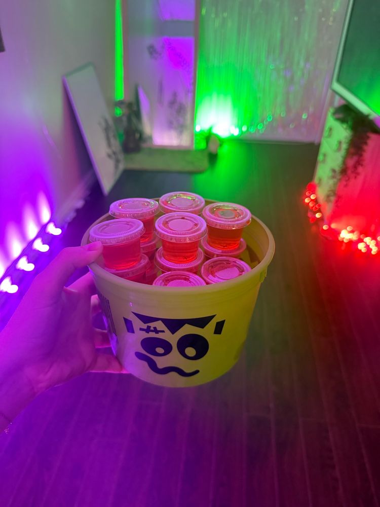 Orange Jell-O shots in a green Frankenstein bucket 