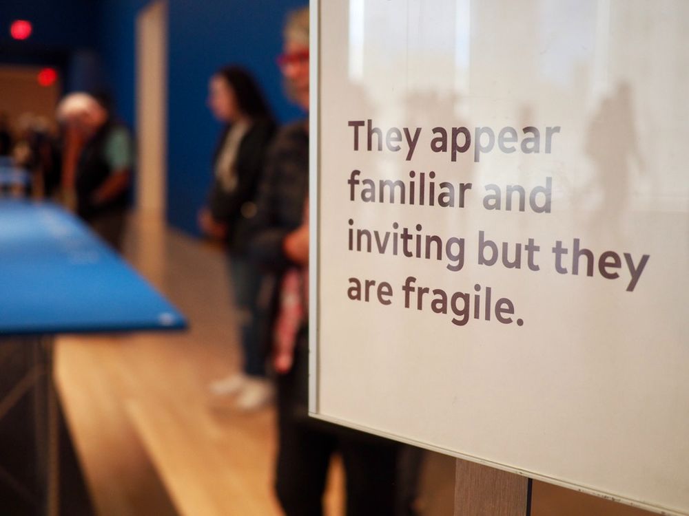 Text on a translucent panel with indistinct figures in the background.
Text on Image: They appear familiar and inviting but they are fragile.